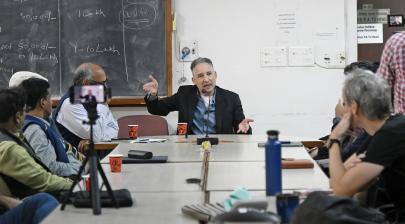 American physicist, Dr. Brian Greene interacting with the faculty